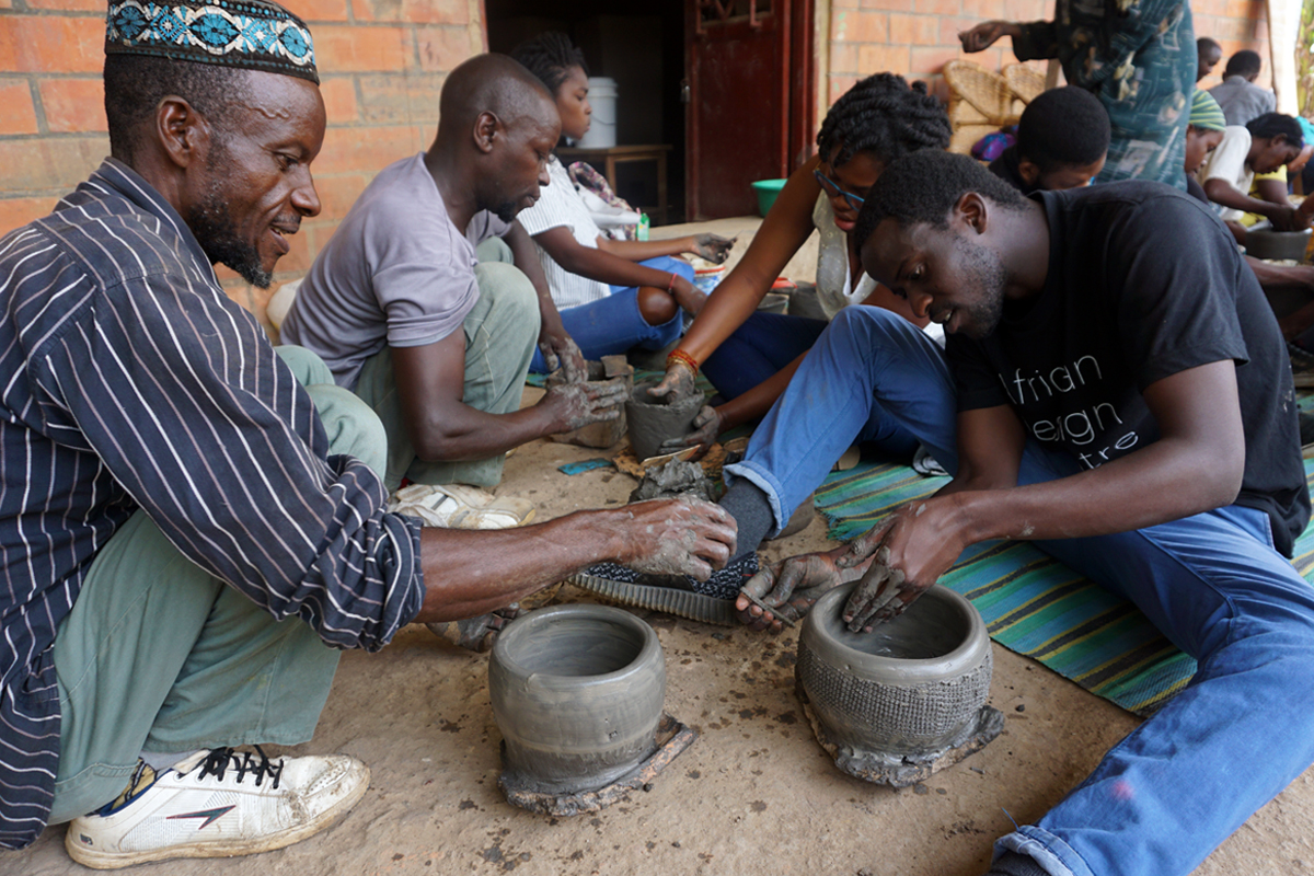 Photo: ADC fellows practicing traditional pottery techniques at Urukundu Village