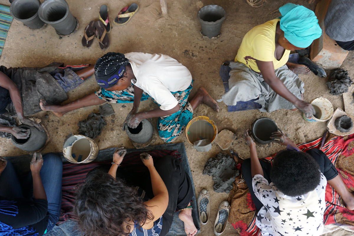 Photo: ADC fellows practicing traditional pottery techniques at Urukundu Village