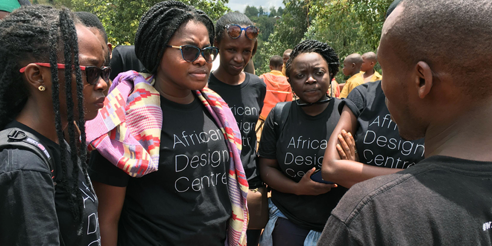 Photo: ADC Fellows on a site visit talk with project manager, Jean Paul Uzabakiriho
