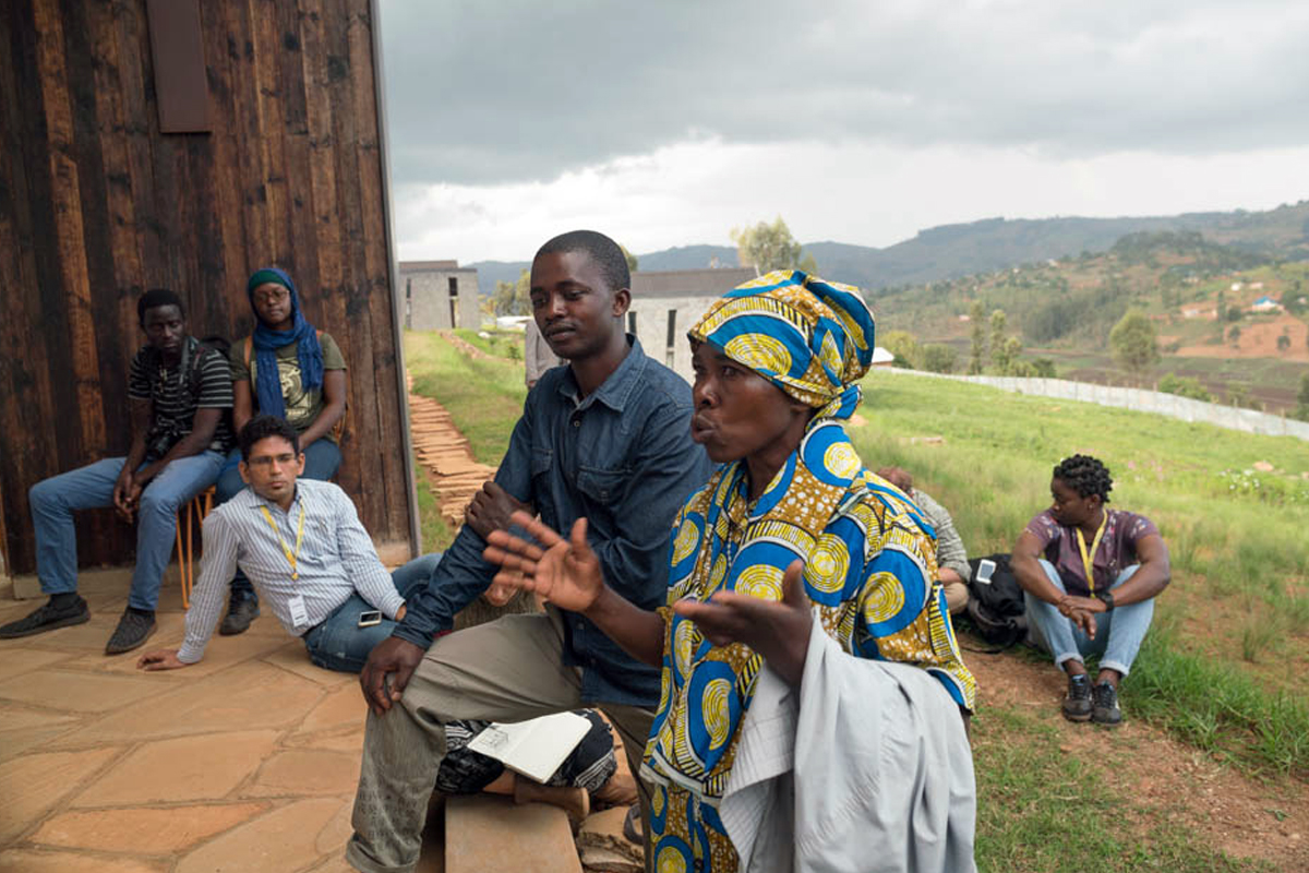 Photo: Butaro stone masons Kankwanze and Hazika advise ADC fellows on best practices for working with local builders on site.