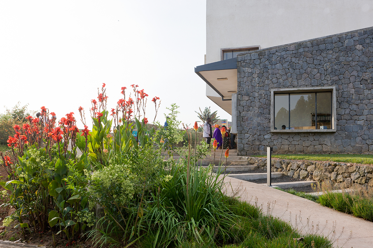 Photo of Butaro District Hospital, Photo by Iwan Baan, View of Gardening in the Butaro Landscape and Masonry Wall