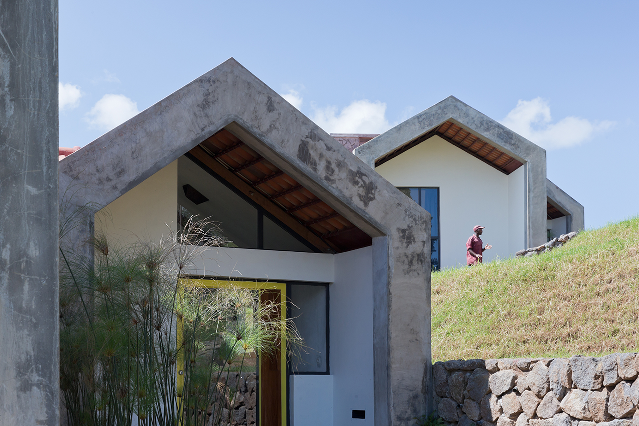 Photo of Butaro Doctors' Housing, Photo by Iwan Baan, Exterior Daytime View of the Hill Side and Multiple Buildings