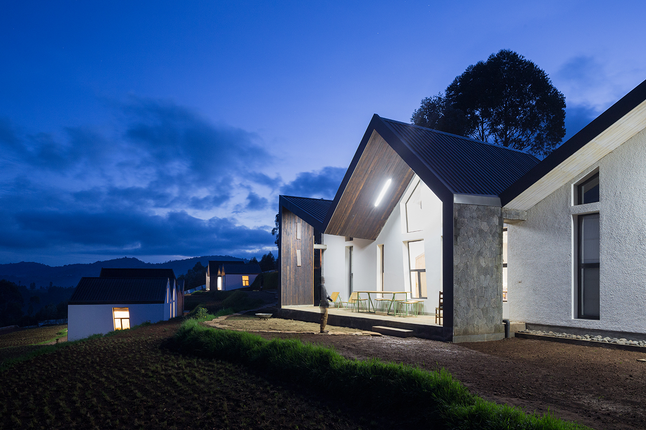Photo of Butaro Doctors' Sharehousing, Photo by Iwan Baan, Totality of Building Nighttime Exterior of the Housing and Landscape