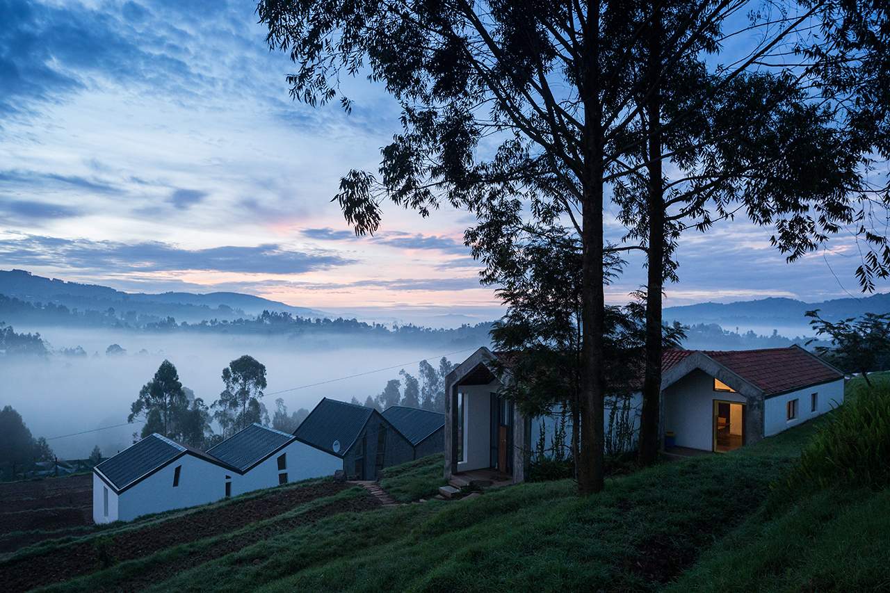 Photo of Butaro Doctors' Sharehousing, Photo by Iwan Baan, Exterior Evening View of the Sharehousing Units, facing Downhill