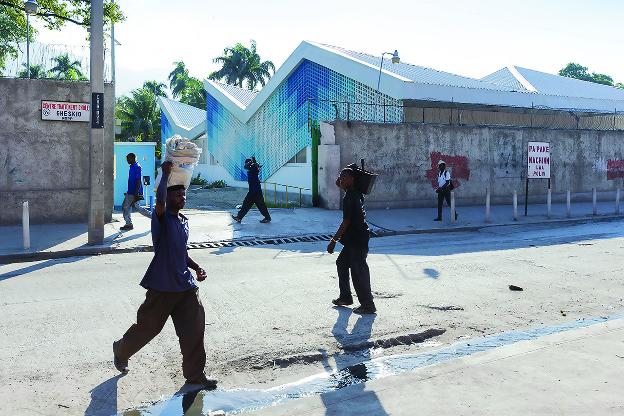 Photo of Gheskio Cholera Treatment Center, Photo by Iwan Baan, Exterior View of Staff Bringing in Custom Furniture