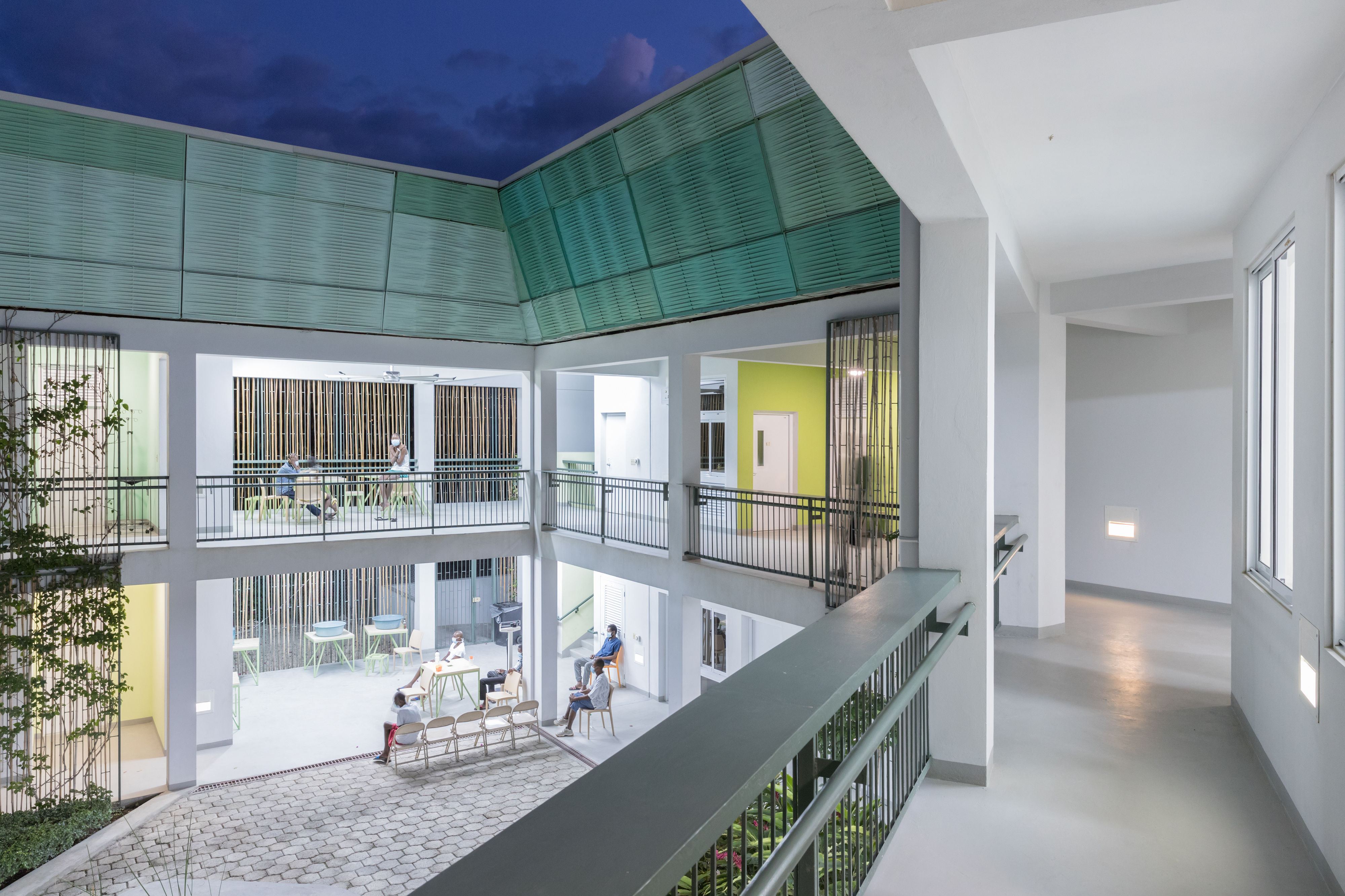 Photo of GHESKIO Tuberculosis Hospital, Photo by Iwan Baan, An evening image of the open-air corridors