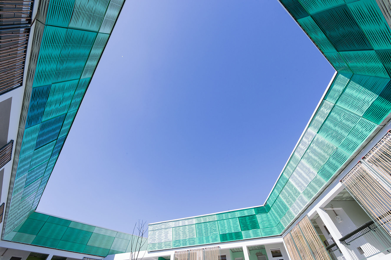 Photo of GHESKIO Tuberculosis Hospital, Photo by Iwan Baan, Exterior View from Middle of the Courtyard to the View of Ventilation Screens
