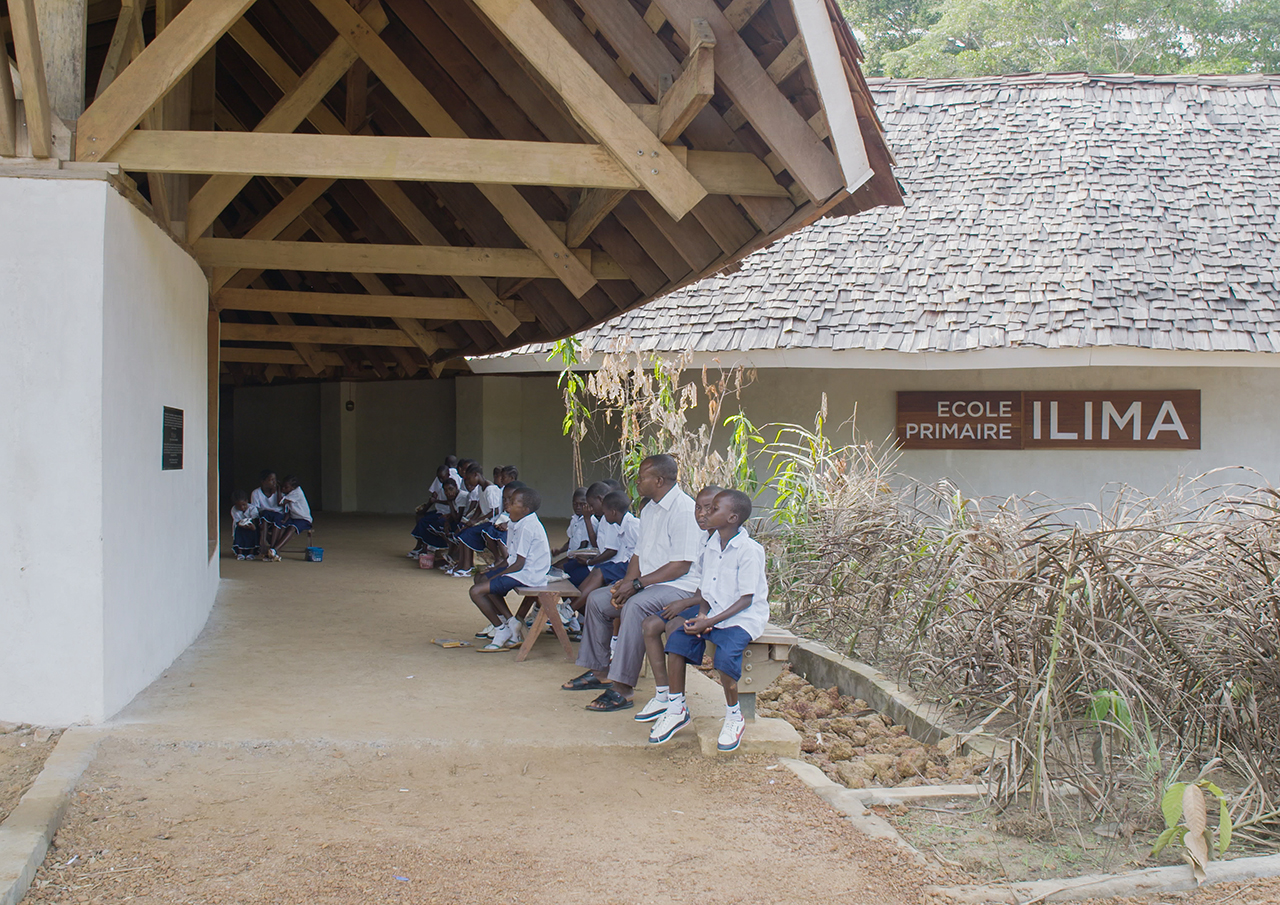 Photo of Ilima Primary School, A view of students sitting near the entrance to the building