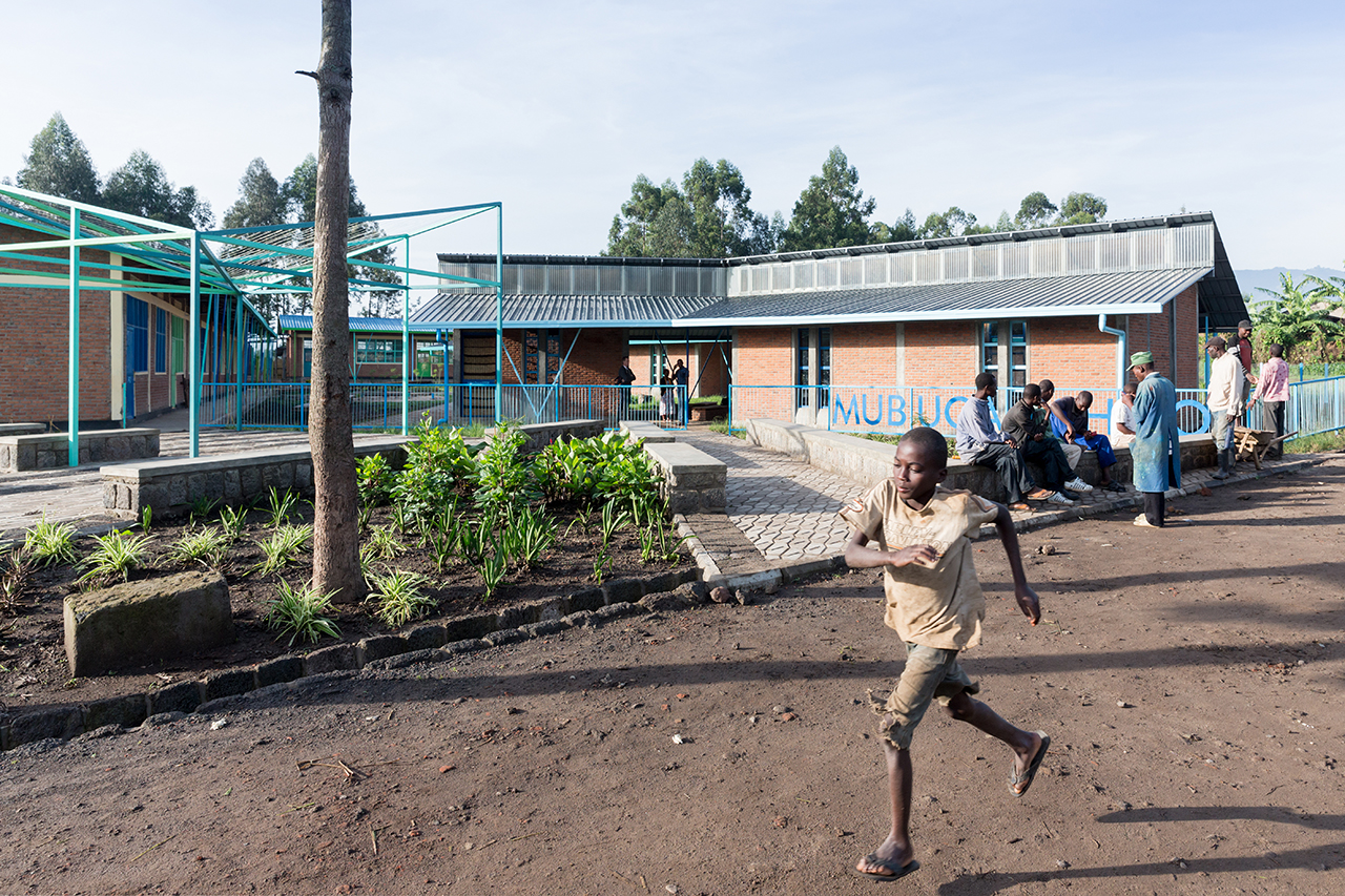 Photo of Mubuga Primary School, Photo by Iwan Baan, Exterior of the school building with children running past