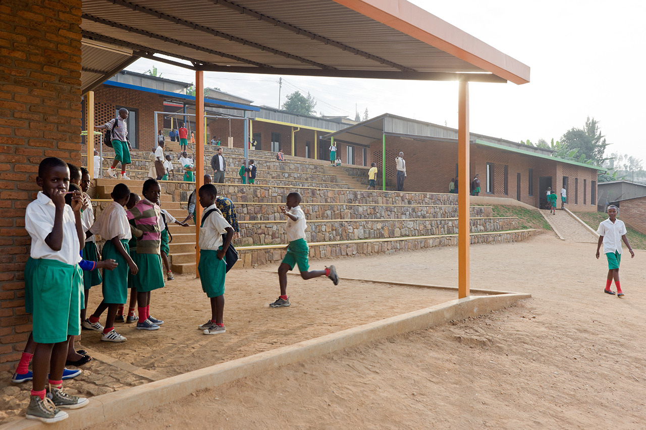 Photo of the Umubano Primary School, Photo by Iwan Baan, View of Tiered Landscape and School Children Playing